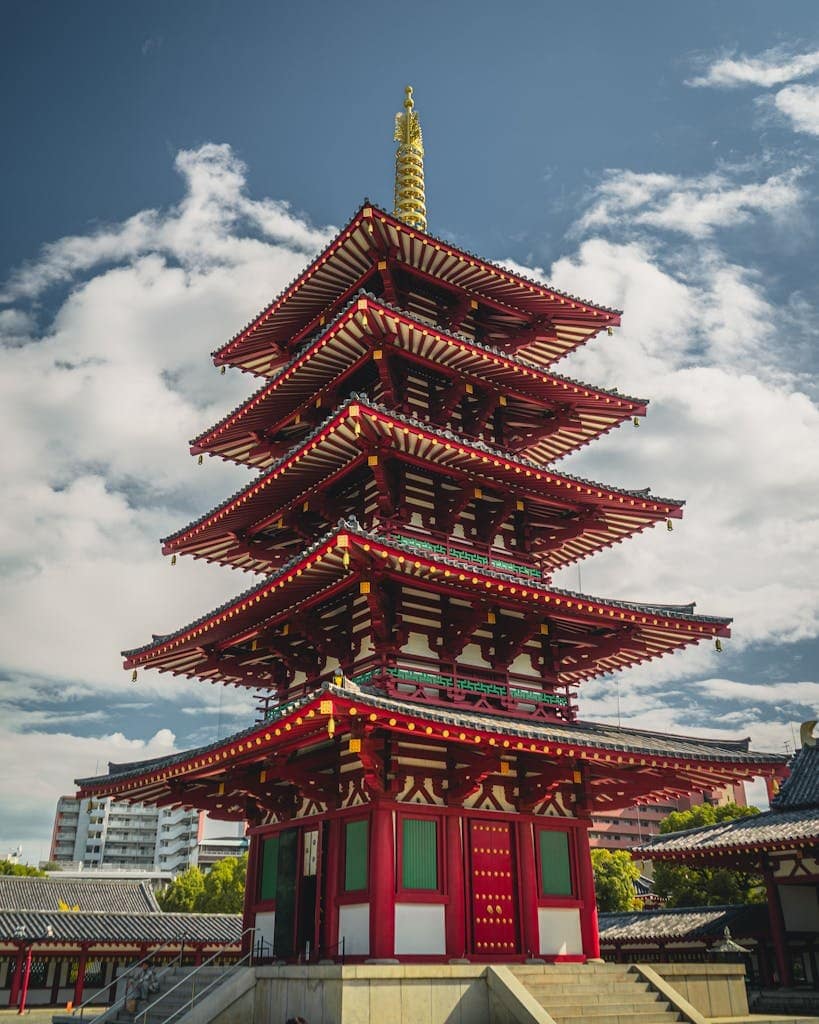 Impressive view of the iconic Shitennoji Temple's pagoda in Osaka, Japan, under a clear sky.