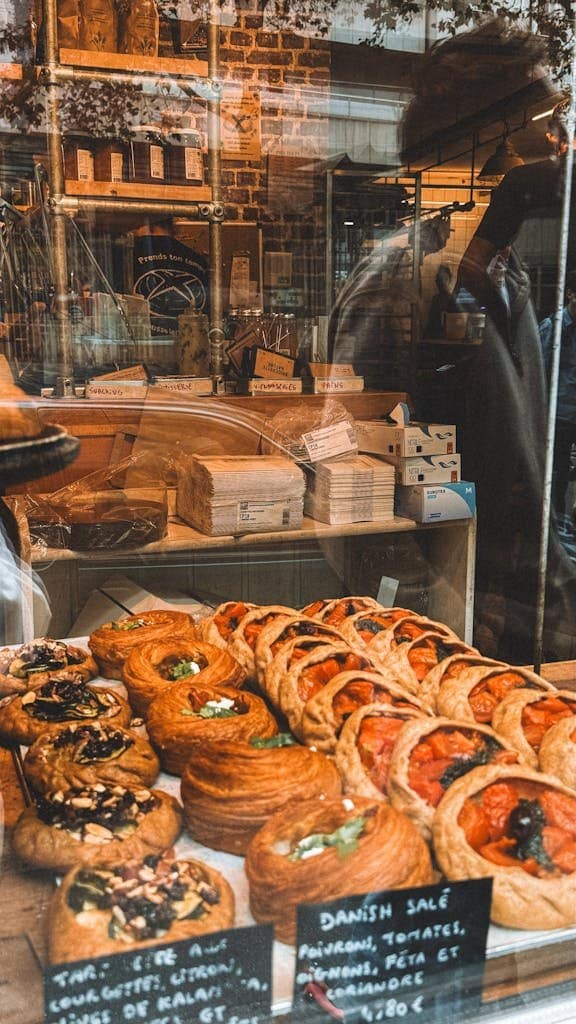 A bustling Parisian bakery window showcasing a variety of pastries.