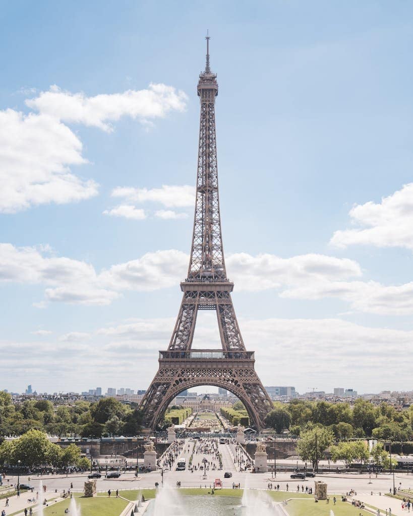 Beautiful daytime view of the Eiffel Tower in Paris, France capturing its grandeur and surroundings.